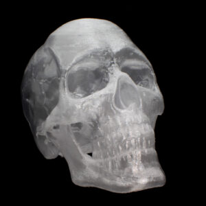 A model of a skull 3D-printed in a transparent, crystal like material.