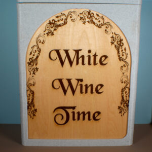 A wine box for bag-in-the-box wine with a white marble frame and an oak panel engraved with the words "White Wine Time".