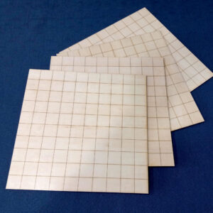 A set of four laminated boards etched with a 1x1 inch grid, for playing tabletop games.